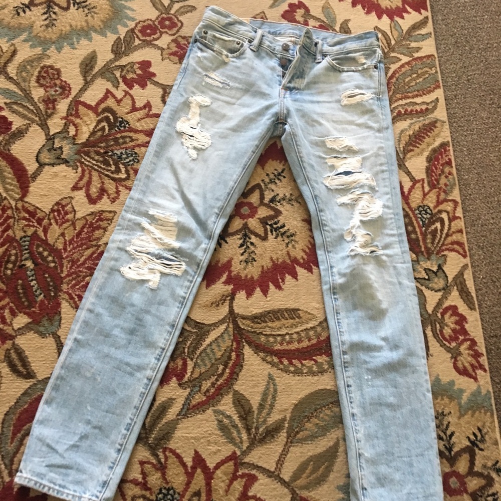 Distressed denim jeans with custom patches